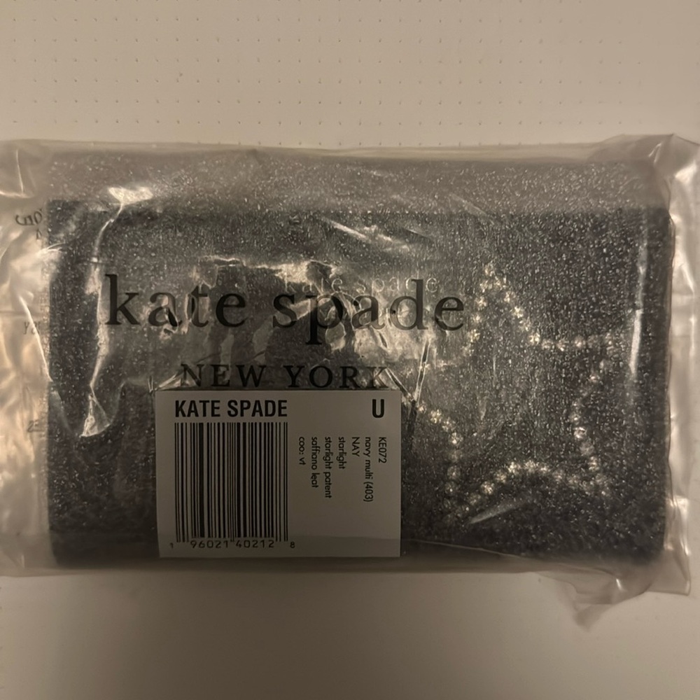 Never used navy Kate Spade star wallet - retails for $128.